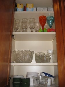 Cabinet above the coffee pot before kitchen organizing.